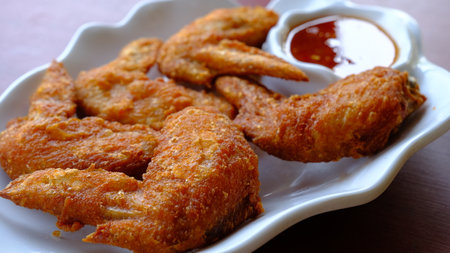 Thai deep fried chicken wing with sweet chili sauce.の写真素材