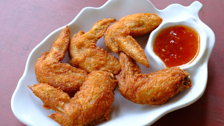 Thai deep fried chicken wing with sweet chili sauce.の写真素材