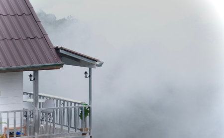 Scenic view of cottages on misty mountain in winter season.の写真素材