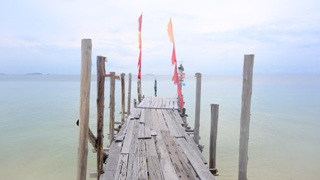 Perspective view of wooden bridge to the calm sea.の写真素材