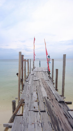 Perspective view of wooden bridge to the clam sea.の写真素材