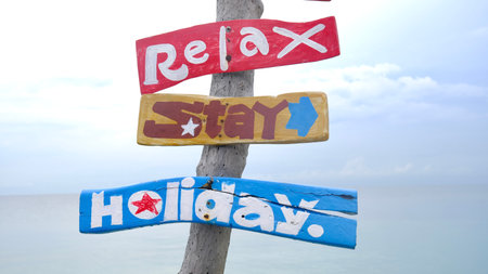 Wooden signpost on the beach, relax stay holiday concept.の写真素材