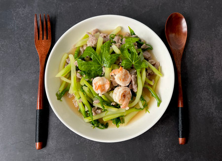 Top view table stir fried tree spinach (chaya) in oyster sauce with shrimp and ground pork.の写真素材