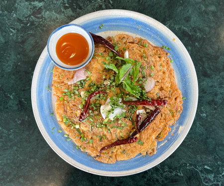 Top view table crispy larb omelet with dried chili and ketchup.の写真素材