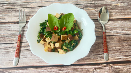 Vegetarian stir fried  basil fresh tofu on wooden background.の写真素材