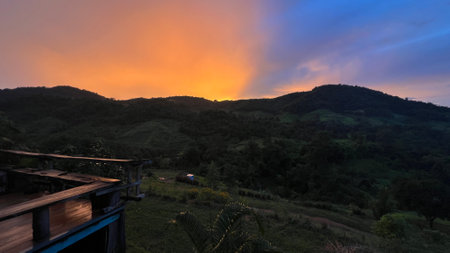Panoramic view of mountain ridge under colorful blue and orange after sunset.の写真素材