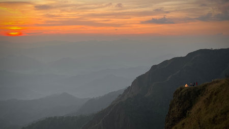 Beautiful sunset in Mountains, popular high mountain hiking trail in Tak province, Thailand, mountain landscape with valleys and slopes.の写真素材