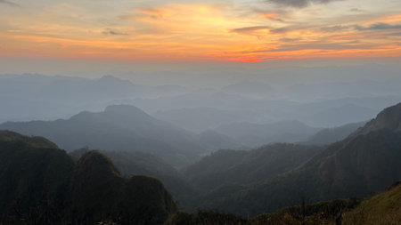 Beautiful sunset in Mon Klui-Jawale-Tule,Mountains, popular high mountain hiking trail in Tak province, Thailand, mountain landscape with valleys and slopes.の写真素材