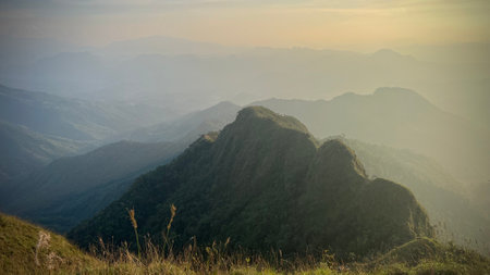 Beautiful sunset in Mountains, popular high mountain hiking trail in Tak province, Thailand, mountain landscape with valleys and slopes.の写真素材