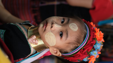 Mae Hong Son, Thailand : Portrait a Kayan ( Padaung) girl wearing traditional brass neck ring and colorful tribal clothing with thanaka on her face, Long neck Karの写真素材
