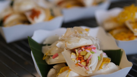 Khanom Buang - Thai traditional dessert, crispy pancakes   with cream and variety toppings, street food.の写真素材