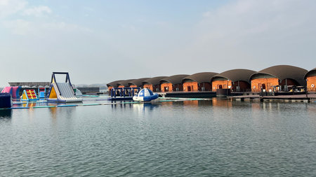Modern floating bungalow on lake with curved roof of Leaf Lake Kan resort, Kanchanaburi, Thailand