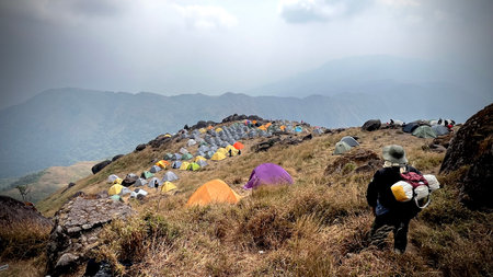 Mulayit Taung, Myanmar : A man travel backpacker on adventure watching camping area on the top of  Mulayit mountain.の写真素材