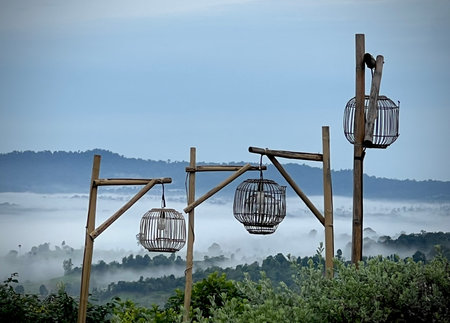 Misty mountain with wooden bamboo lamppost.の写真素材