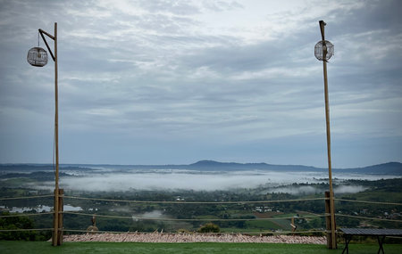 Misty mountain with wooden bamboo lamppost.の写真素材