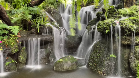 Beautiful waterfall in the tropical garden, long exposure shot with slow shutter speedの写真素材