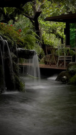 Beautiful waterfall in the tropical garden, long exposure shot with slow shutter speedの写真素材