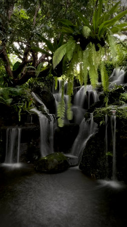 Beautiful waterfall in the tropical garden, long exposure shot with slow shutter speedの写真素材