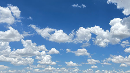 White cumulus clouds against blue sky, cloudscape in the skyの写真素材