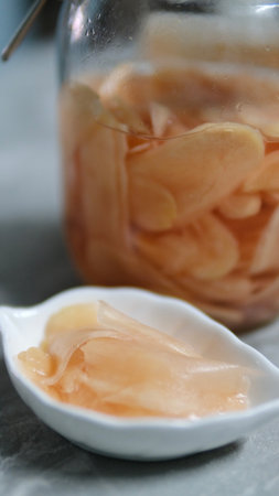 Pickled ginger in a glass jar. Selective focus. Close up.の写真素材