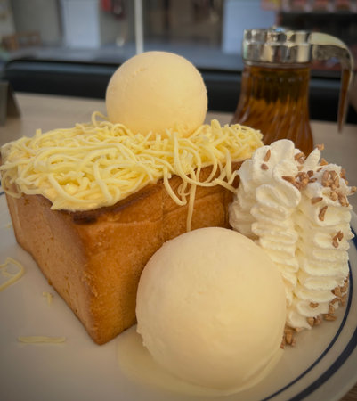 Honey toast with ice-cream and whipped cream on top.の写真素材