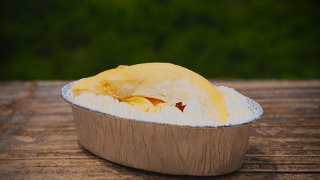 Durian cake in  bowl on wood table with nature background.の写真素材