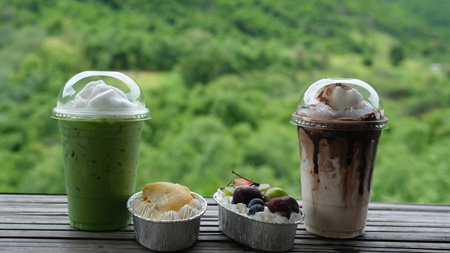 set of beverage ice green tea, ice chocolate and fruit cake with nature bacegroundの写真素材