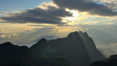 Stunning sunset view with dramatic sun rays over the Doi Luang Chiang Dao mountain range, Chiang...