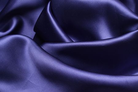 A sheet of blue satin caressly drapedの写真素材