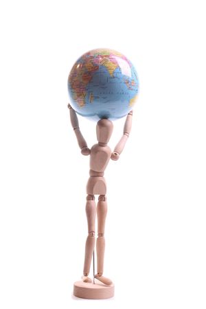 Wooden doll playing Atlas on a withe isolated background with copy spaceの写真素材