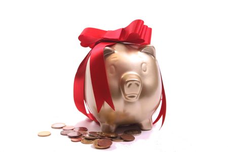 Piggybank as a present on a withe isolated background with copy spaceの写真素材