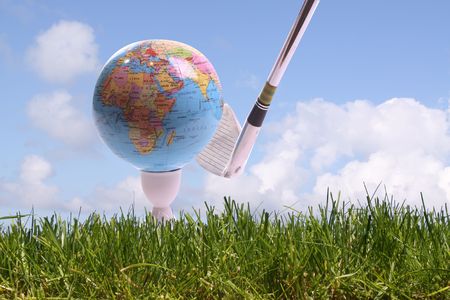 Golfball in gras is going to hit by a golfclubの写真素材