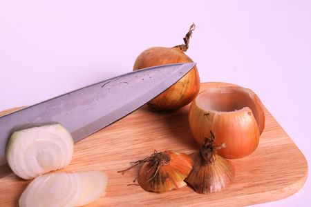 Fresh onion on a cutting board on a withe isolated background with copy spaceの写真素材