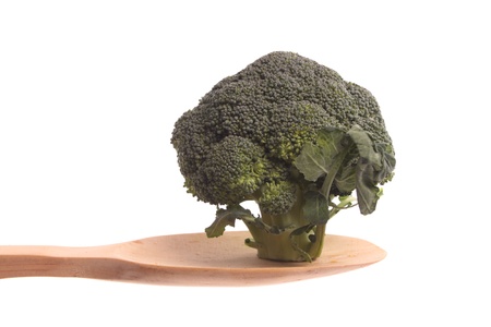 Broccoli  simply offered on a wooden spoon isolated on a white background の写真素材