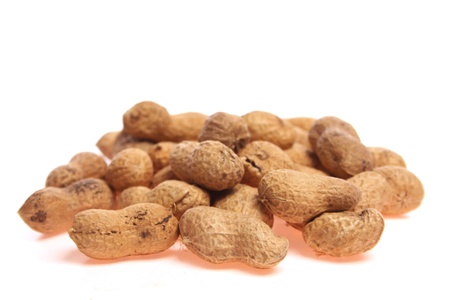 Unpeeled peanuts isolated against a white background with copy spaceの写真素材