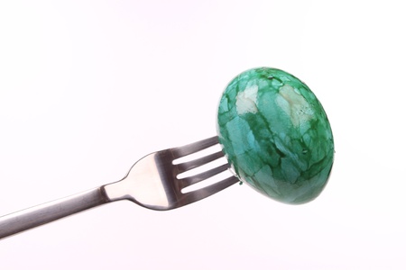 eateregg  on a fork isolated over white backgroundの写真素材