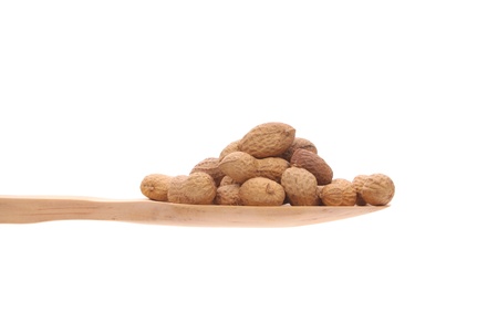 Peanuts simply offered on a wooden spoon isolated on a white background 