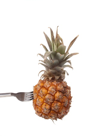Pineapple on a fork isolated against a white backgroundの写真素材