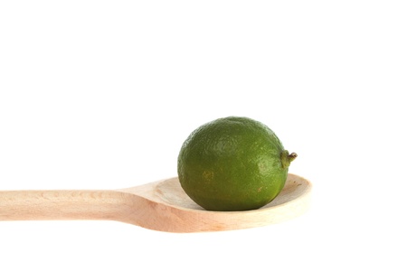 Lime on a wooden spoon  isolated against a white backgroundの写真素材
