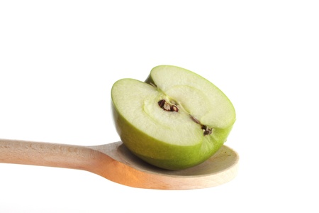 Apple on a wooden spoon isolated against a white backgroundの写真素材