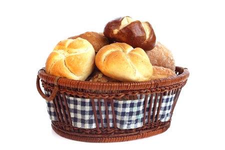 Various bread rolls in a basket against a white backgroundの写真素材