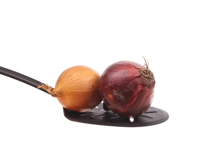 Onion on a spoon against a white backgroundの写真素材