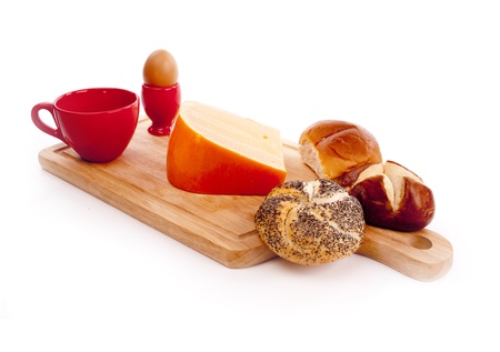 Simple breakfast with a boiled egg, cheese and a bunの写真素材