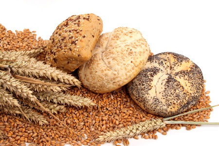 Fresh baked bread and wheat in a studio setting