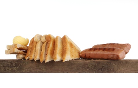 Various kinds of bread loaf and buns on a shelf in a studio settingの写真素材