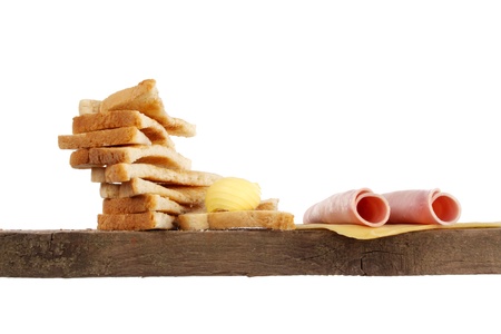 Various kinds of bread loaf and buns on a shelf in a studio setting