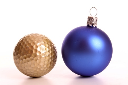 Golden golf ball and a Christmas baulbの写真素材
