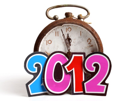 Clock  approaching the New Year 2012 over white