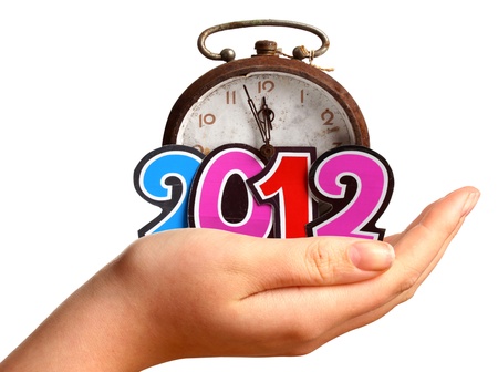 Clock in a young womans hand  approaching the New Year 2012 over white