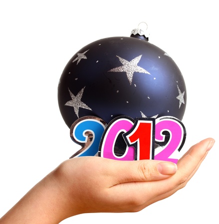 Young womans hand for New Year 2012 and a bauble in the studio